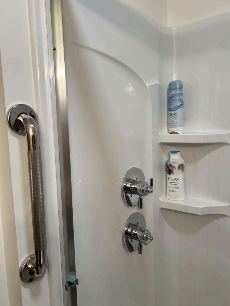 Grab bars installed in a Sterling walk-in shower as part of an accessible bathroom remodel in Columbus, Indiana