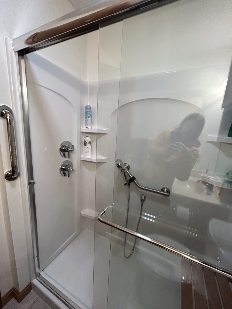 Sterling fiberglass walk-in shower with a glass door and accessibility upgrades in Columbus, Indiana.