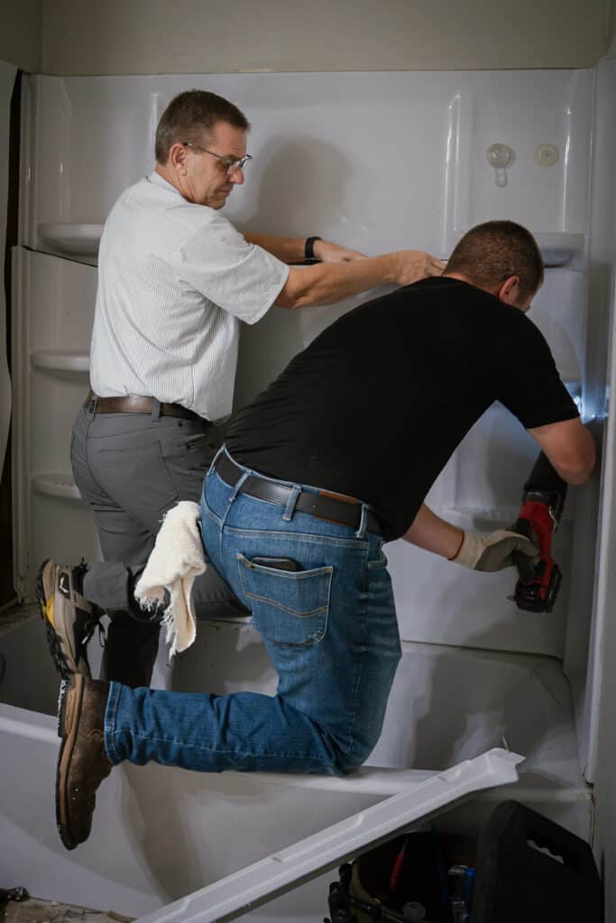 David & Braydon removing shower unit