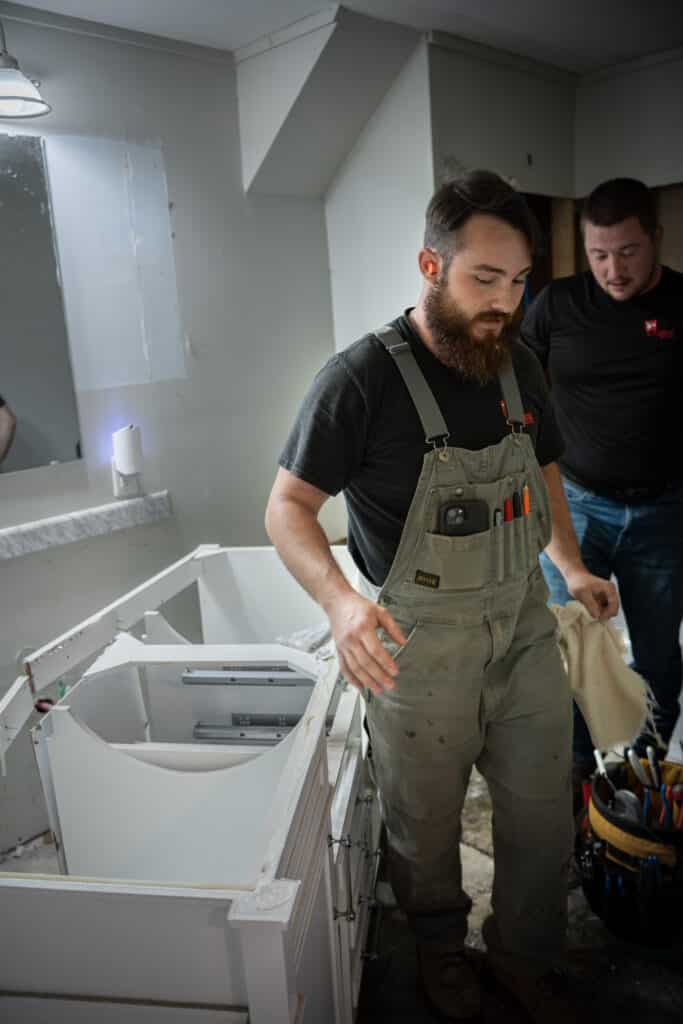 Two plumbers in the middle of demo day.