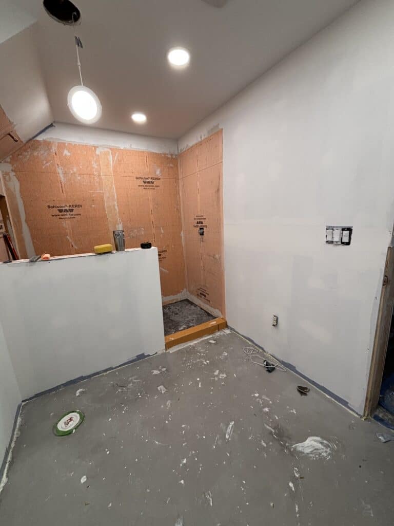 View of bathroom progress including work on the tile shower.