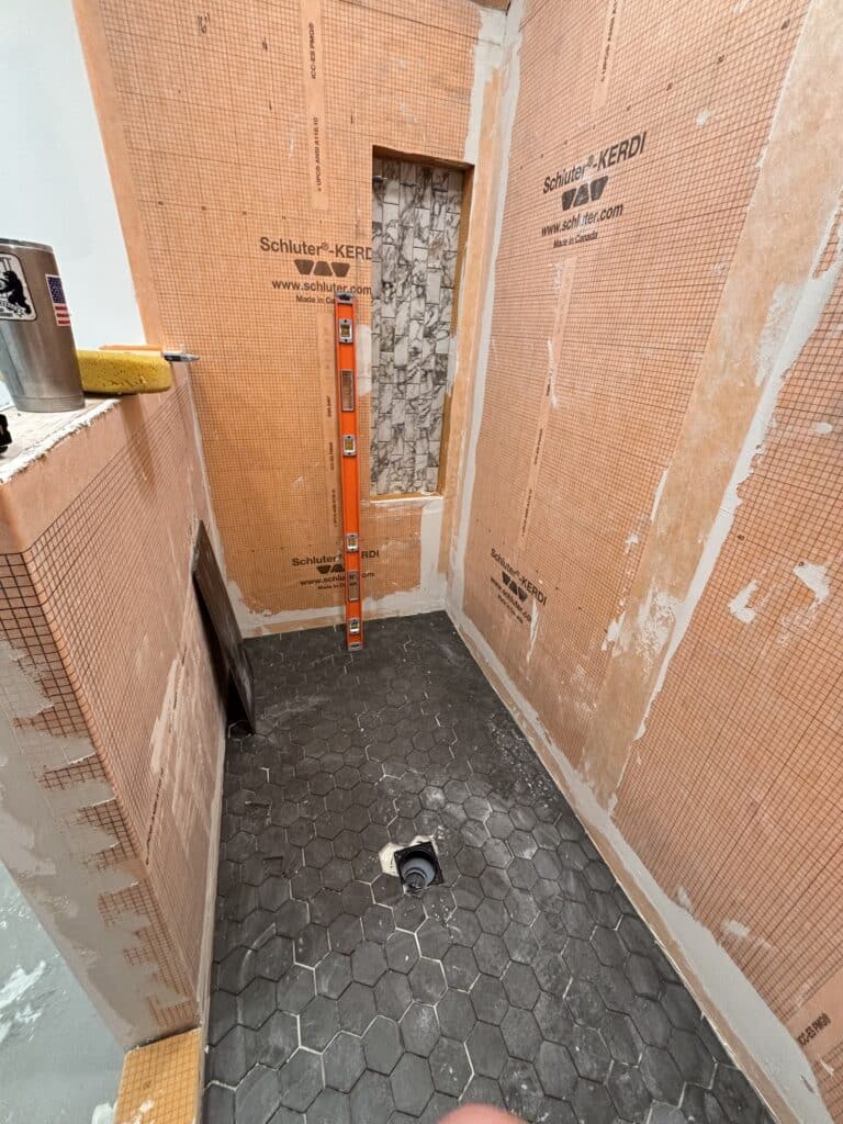 Updated work on the tile shower for a bathroom remodel.