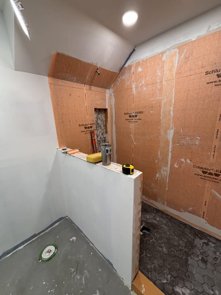 Updated work on the tile shower for a bathroom remodel.